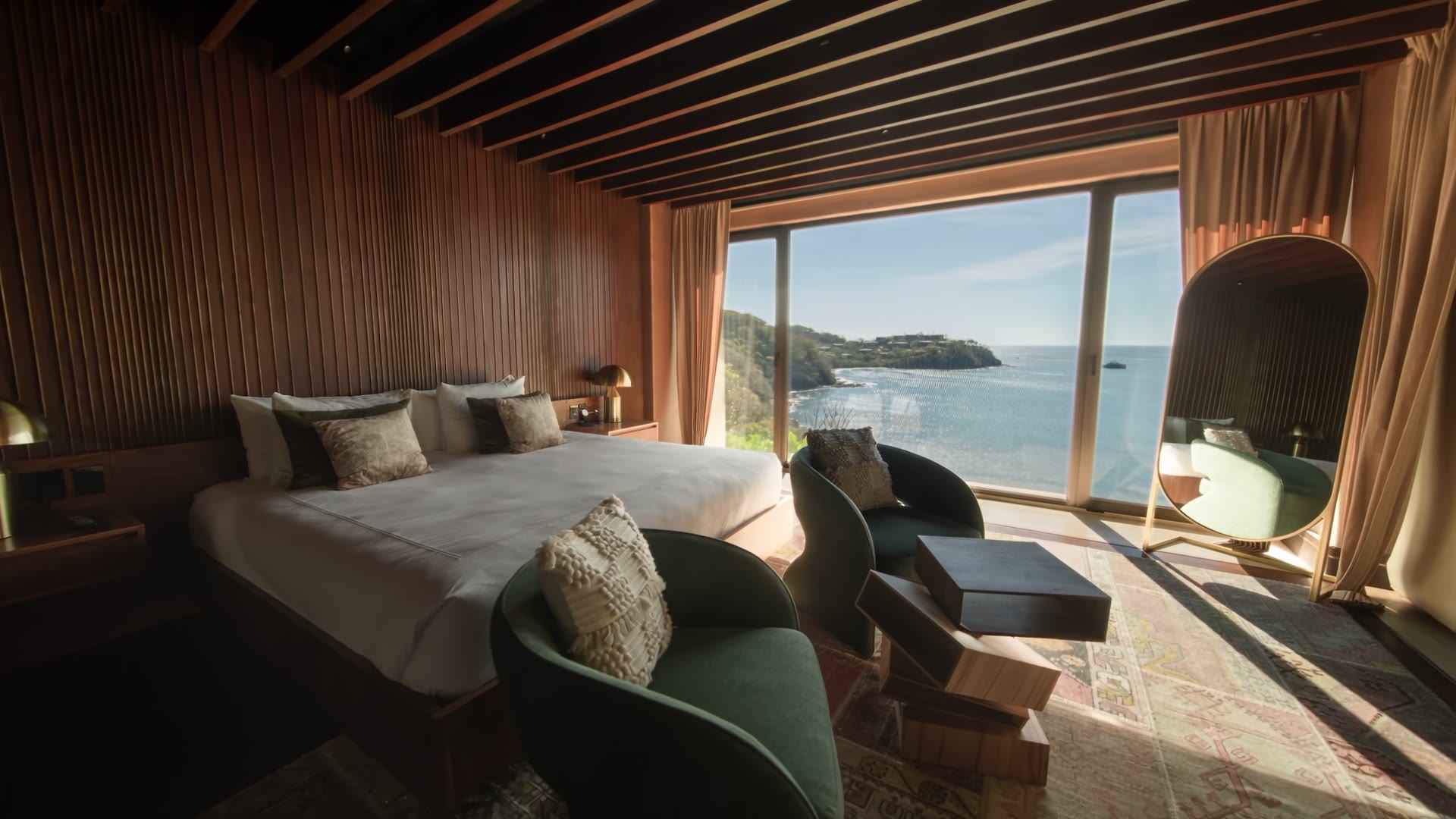 Timber-lined bedroom overlooking the sea in The Hive property film